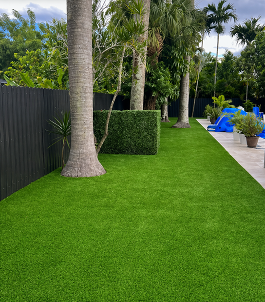 Residential Artificial Turf Installation South Florida Residential artificial turf installation in South Florida backyard with low maintenance lawn and year round green grass